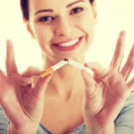 woman breaking cigarette